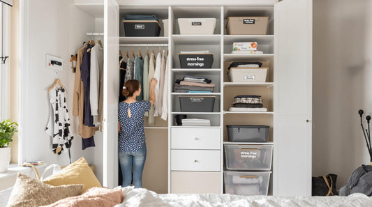 Modern closet with DIY dividers, person enjoying organized clothing