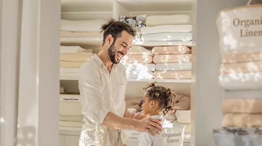 Family organizing fresh linens in a bright, tidy closet space